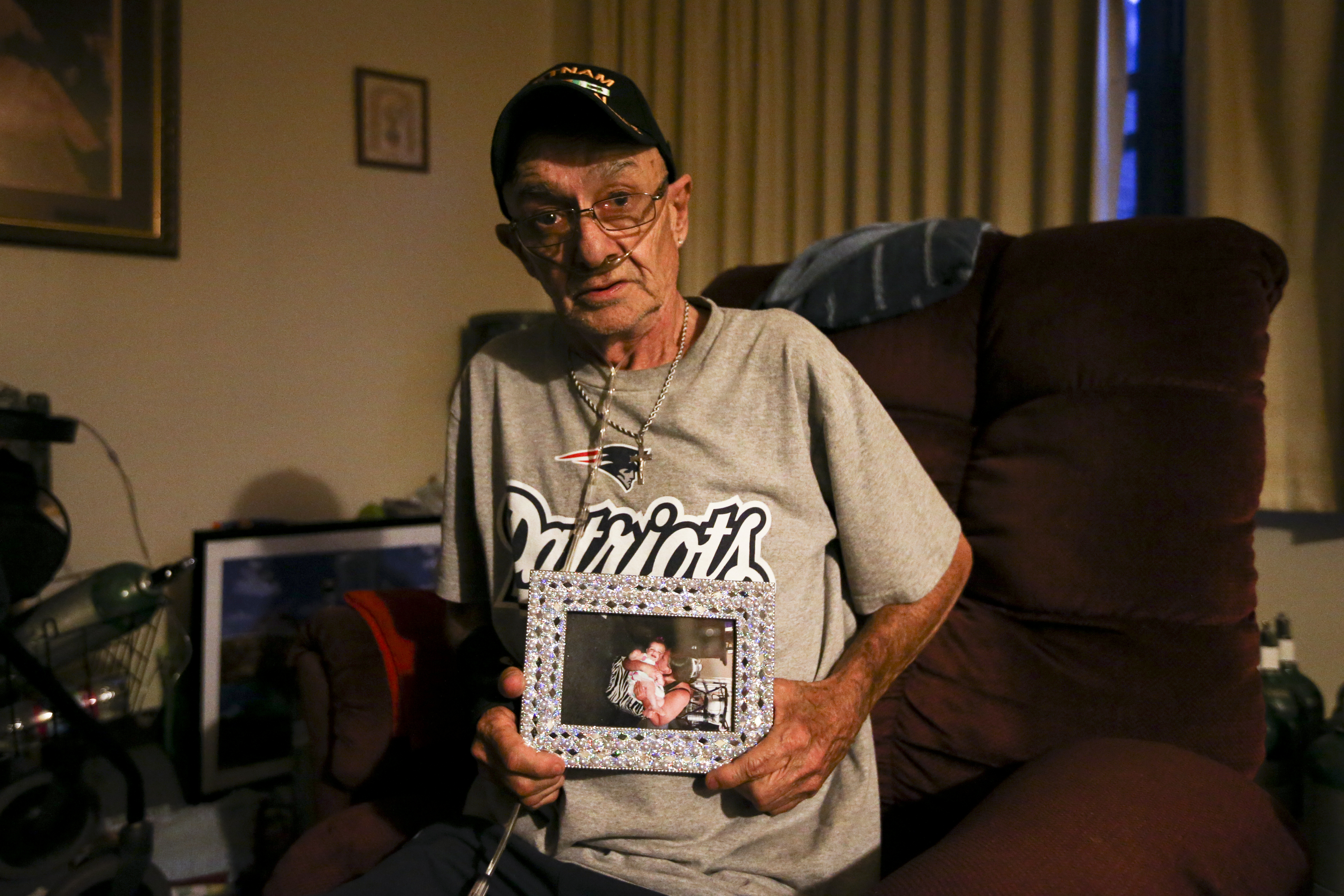 David Coxon, 69, held a picture of his daughter, Jessica, and granddaughter, Avalena, in his Marlborough home.