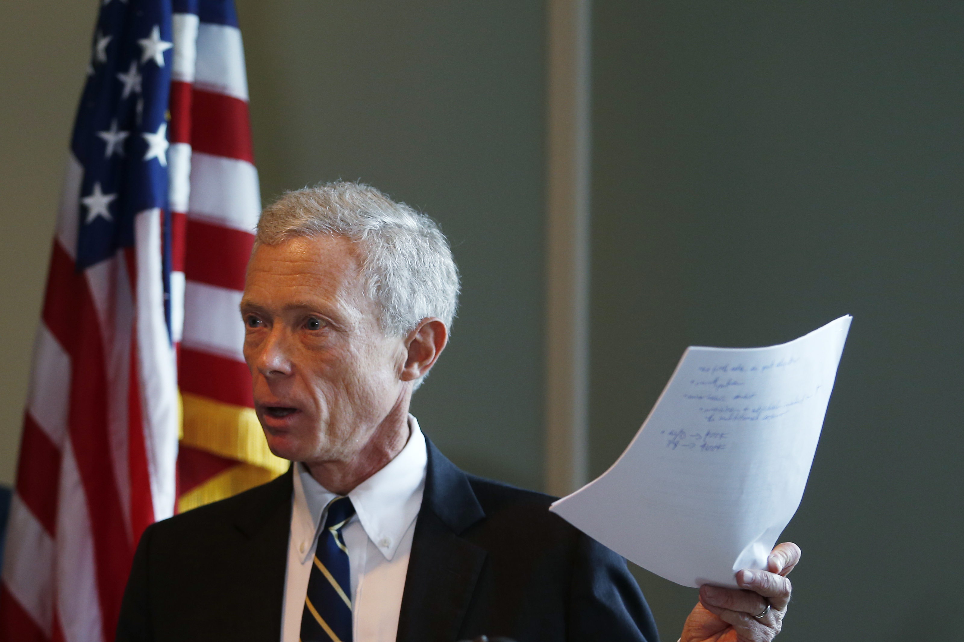 New Hampshire Attorney General Gordon MacDonald held up a copy of the agreement made with St. Paul's School during a press conference in Concord, N.H., Thursday.