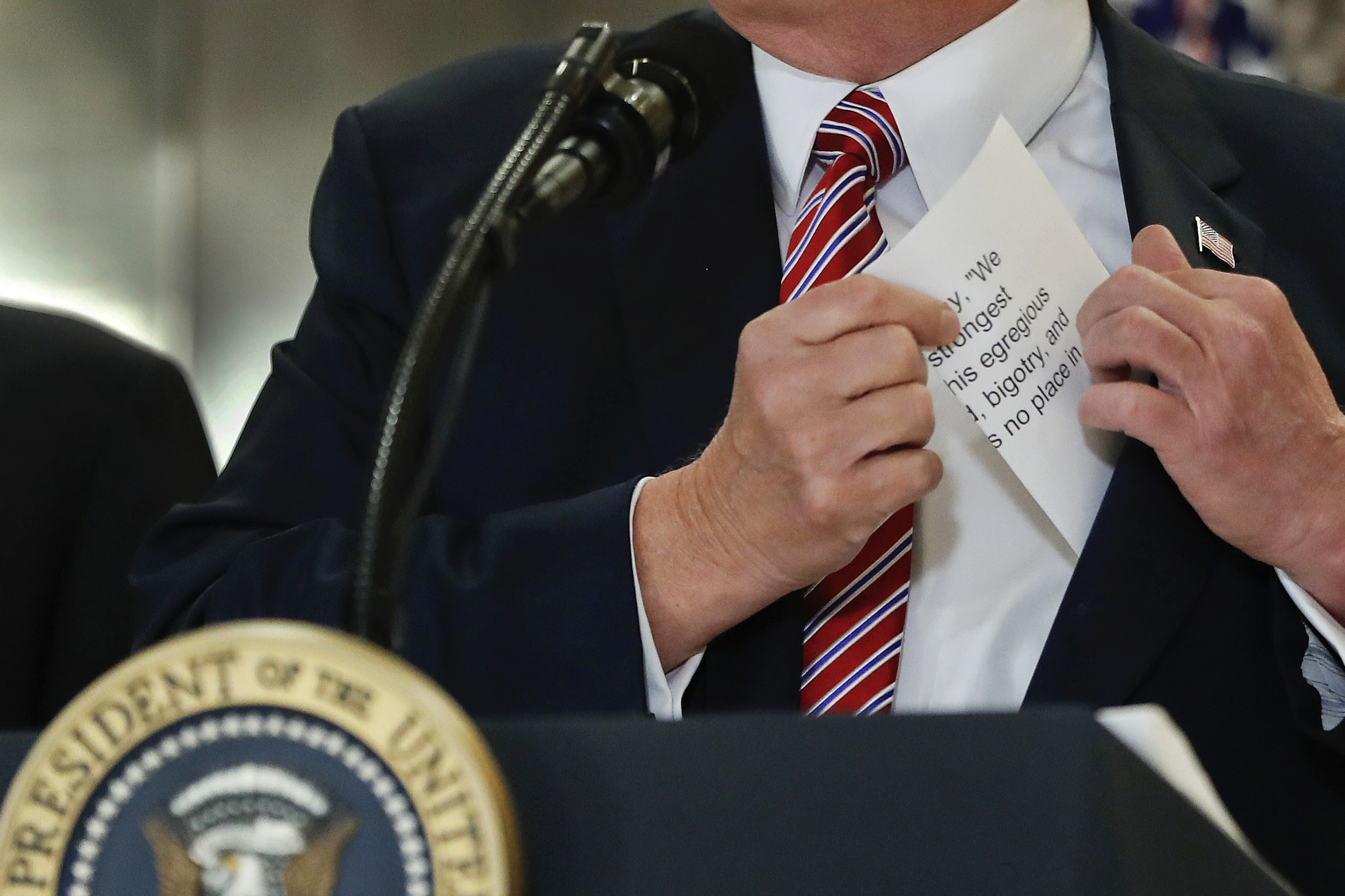 Trump reached into his suit jacket for a piece of paper with the statement he made on Saturday regarding the Charlottesville, Va., violence.