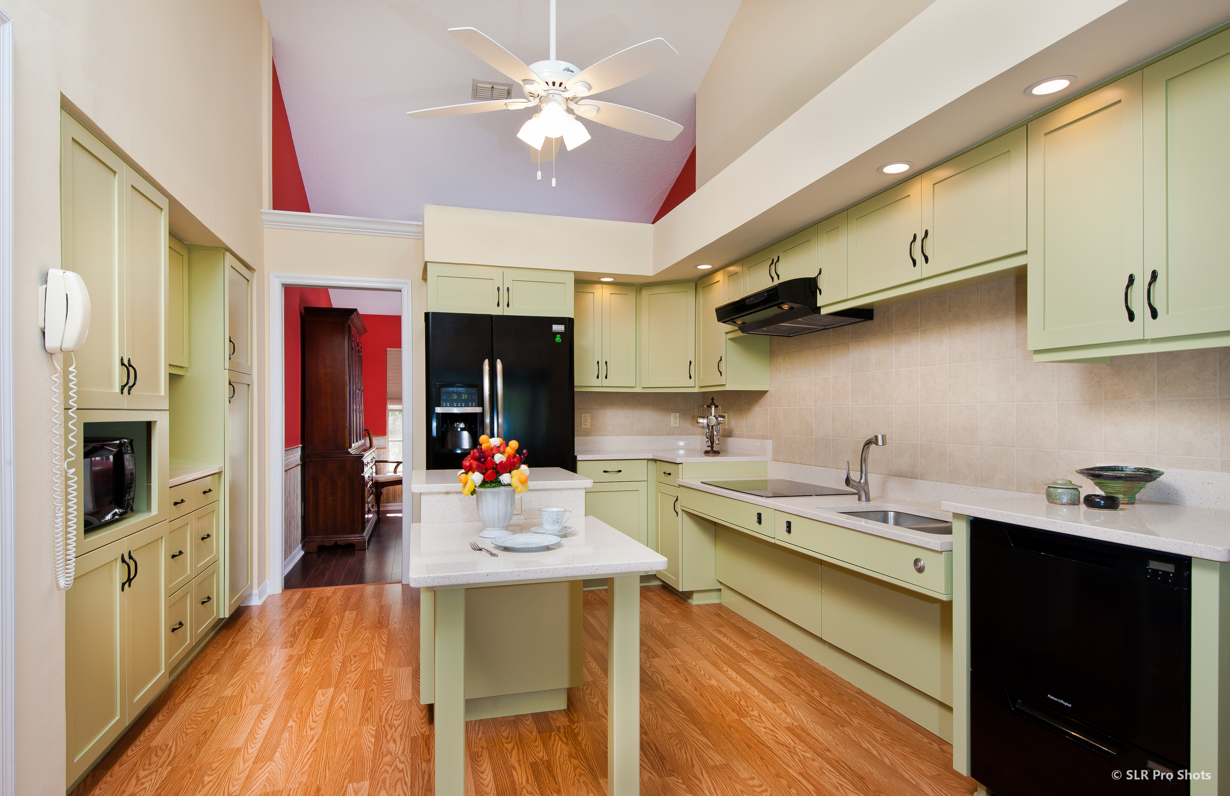 This kitchen has been designed to accommodate older residents, anticipating a loss of faculities as they age. The main work spaces have been lowered and appliances put into easier reach.