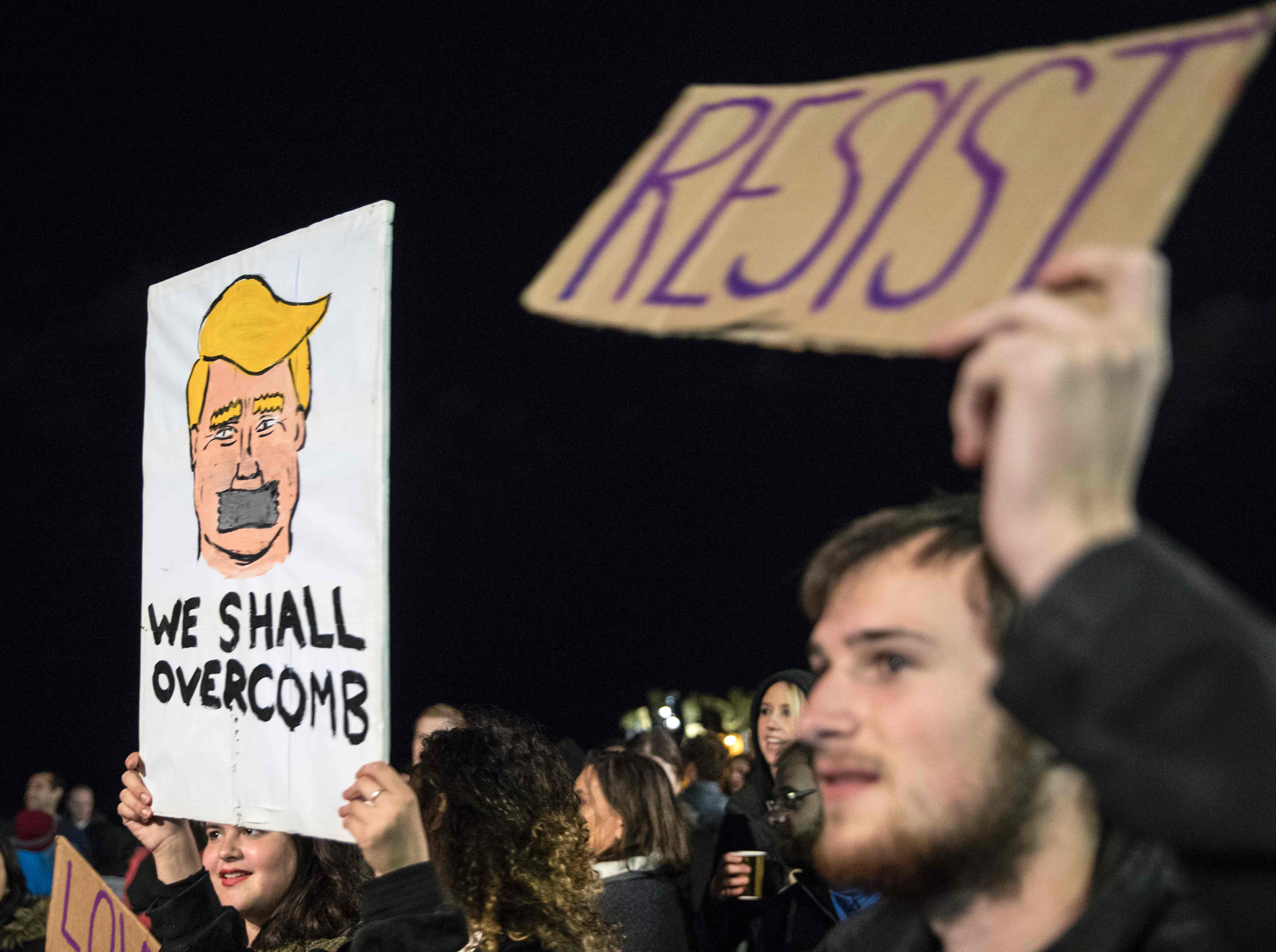 Demonstrators held placards during a protest outside the US embassy in the Israeli city of Tel Aviv against President Donald Trump.