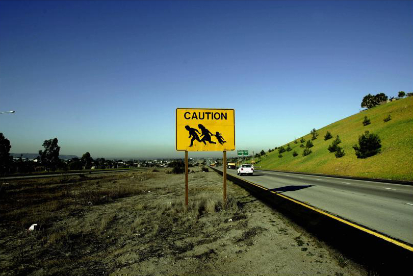 A sign on a freeway warned drivers of people crossing in Chula Vista, California.