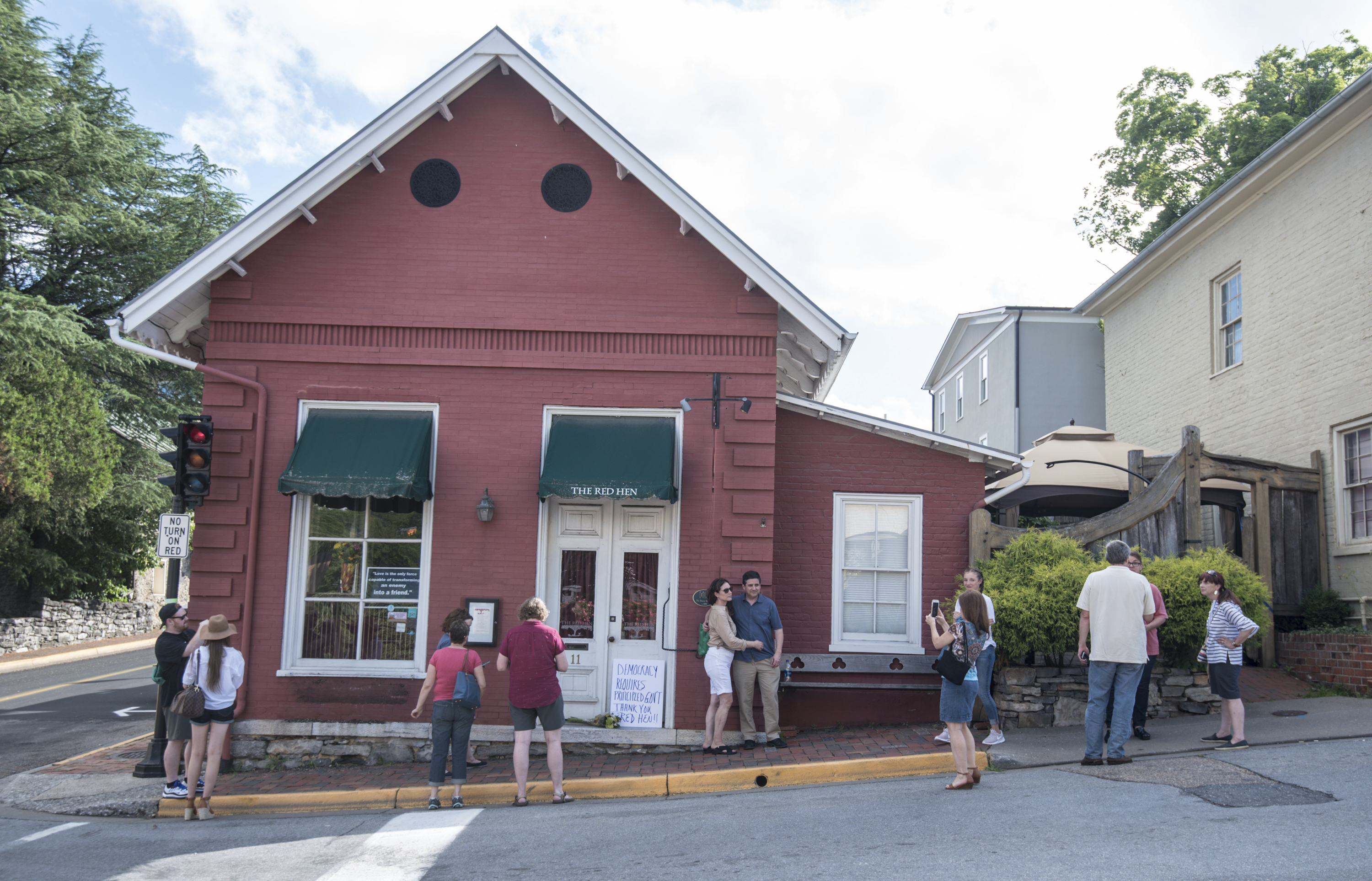Passersby gathered to take photos in front of the Red Hen Restaurant on Saturday.