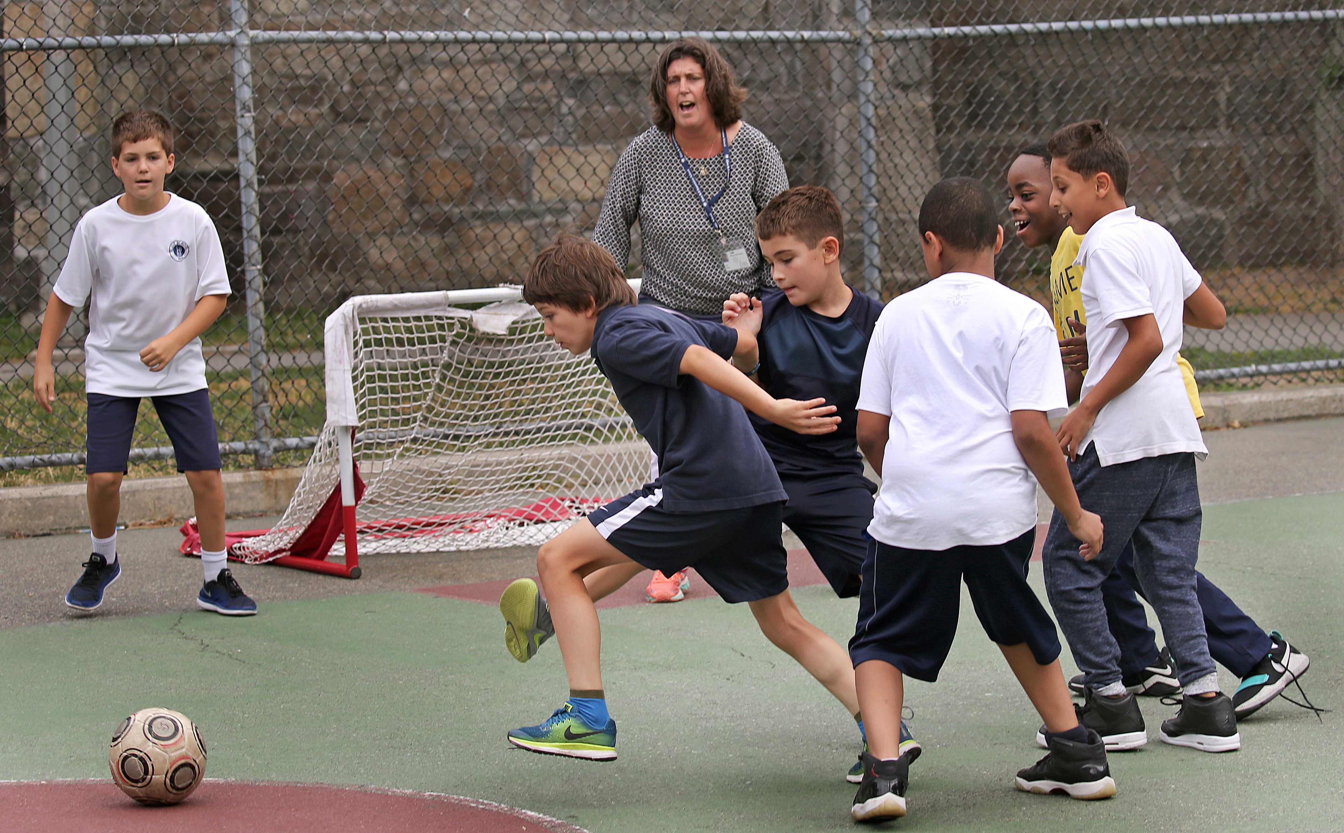 Eliot School students played soccer with principal Traci Walker Griffith guarding the net during recess.